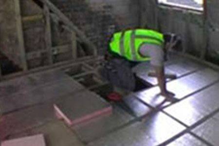 Installer fitting rigid insulation boards