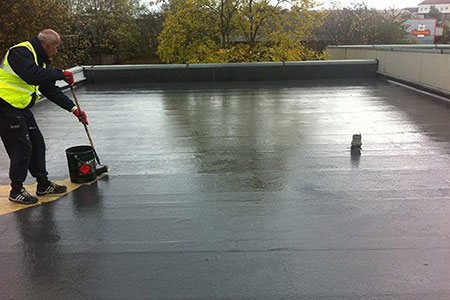 Roofer finishing a commercial flat roof